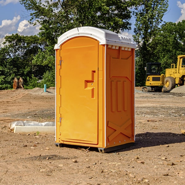 what is the cost difference between standard and deluxe portable restroom rentals in Arbela